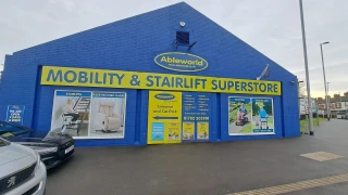 Blue painted retail building with large yellow signage and storefront windows